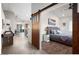 View from the Living Room to the Main Bedroom which features barn doors, a ceiling fan and neutral décor at 3224 E Desert Cove Ave, Phoenix, AZ 85028