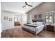 Spacious main bedroom features high ceilings, wood floors, and an ensuite bathroom with abundant natural light at 3224 E Desert Cove Ave, Phoenix, AZ 85028