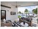 Inviting covered patio with comfortable seating, ceiling fan, and a view of the pool and palm trees at 3224 E Desert Cove Ave, Phoenix, AZ 85028