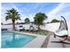 Inviting backyard pool area with lounge chairs, shade umbrellas, and decorative egg chair at 3224 E Desert Cove Ave, Phoenix, AZ 85028