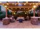 Backyard patio with a pergola, outdoor seating, and ambient string lights for relaxing evenings at 3460 E Lynx Pl, Chandler, AZ 85249