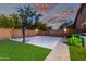 Basketball court with adjustable hoop in backyard, enhanced with artificial turf and pavers at 3460 E Lynx Pl, Chandler, AZ 85249