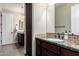 Bathroom with granite countertop, dark wood cabinetry and multiple sinks at 3460 E Lynx Pl, Chandler, AZ 85249