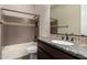 Bathroom with granite countertop, dark wood cabinetry and tiled shower with decorative accents at 3460 E Lynx Pl, Chandler, AZ 85249