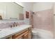 Stylish bathroom featuring a unique pink-tiled backsplash and shower with modern fixtures at 3460 E Lynx Pl, Chandler, AZ 85249