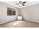 Neutral bedroom features a ceiling fan, wood-look tile floors, and a window for natural light at 3460 E Lynx Pl, Chandler, AZ 85249
