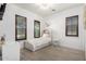 Bright bedroom features wood-look tile floors, white walls, and shuttered windows at 3460 E Lynx Pl, Chandler, AZ 85249