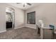 Bedroom with plantation shutters and view to bathroom featuring natural light at 3460 E Lynx Pl, Chandler, AZ 85249