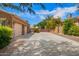 Spacious driveway leading to a three-car garage, complemented by desert landscaping and privacy fencing at 3460 E Lynx Pl, Chandler, AZ 85249