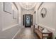 Inviting foyer with beautiful tile flooring, decorative mirror, and elegant chandelier at 3460 E Lynx Pl, Chandler, AZ 85249