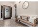 Attractive foyer featuring wood-look tile flooring, decorative mirror, and welcoming bench at 3460 E Lynx Pl, Chandler, AZ 85249