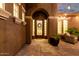 Inviting front entrance of home featuring a decorative iron door, stylish sidelights, and elegant architectural details at 3460 E Lynx Pl, Chandler, AZ 85249