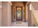Elegant front entrance with a decorative glass door, sidelights, and a 'Welcome' mat, creating a warm and inviting ambiance at 3460 E Lynx Pl, Chandler, AZ 85249