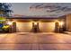 Well-lit three-car garage with elegant stone accents, offering ample parking and curb appeal at 3460 E Lynx Pl, Chandler, AZ 85249