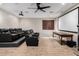 Home theater with projector, screen, and plush black reclining seating for optimal viewing experience at 3460 E Lynx Pl, Chandler, AZ 85249