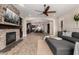 Open-concept living room with stone fireplace flowing into kitchen with an island and breakfast bar at 3460 E Lynx Pl, Chandler, AZ 85249
