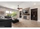 Spacious living room featuring a stone fireplace, wood floors, and backyard views at 3460 E Lynx Pl, Chandler, AZ 85249