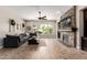 Cozy living room with stone fireplace, wood floors, and large windows at 3460 E Lynx Pl, Chandler, AZ 85249