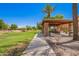 Park gazebo with picnic table and bench, alongside a green lawn at 3460 E Lynx Pl, Chandler, AZ 85249