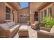 Cozy outdoor patio area with wicker furniture, a charming rug, and string lights creating an inviting space for relaxation at 3460 E Lynx Pl, Chandler, AZ 85249