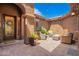 Inviting outdoor patio with wicker furniture, stylish potted plants, and string lights, perfect for relaxation and entertaining at 3460 E Lynx Pl, Chandler, AZ 85249