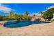 Spacious backyard pool with a rock waterfall feature and lush landscaping, perfect for outdoor entertaining at 3460 E Lynx Pl, Chandler, AZ 85249