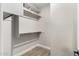 Bright walk-in closet boasts wood-look tile flooring and white shelving and racks for ample storage at 3460 E Lynx Pl, Chandler, AZ 85249