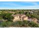 Aerial view of a residential property with a large yard, garages, manicured landscaping, and convenient circular driveway at 3523 E Presidio Cir, Mesa, AZ 85213