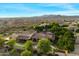 Expansive aerial view of the property showcasing the lush landscaping, custom pool, and surrounding landscape at 3523 E Presidio Cir, Mesa, AZ 85213