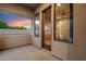 Relaxing outdoor balcony with views and wood trimmed glass doors allowing natural light to enter the home at 3523 E Presidio Cir, Mesa, AZ 85213