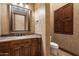Elegant bathroom featuring a granite countertop, stylish vanity, and a framed mirror creating a sophisticated space at 3523 E Presidio Cir, Mesa, AZ 85213