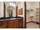 Bathroom with wood cabinets, granite counters, a vanity mirror, and walk-in closet at 3523 E Presidio Cir, Mesa, AZ 85213