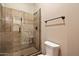 Bathroom featuring a glass enclosed shower, tile surround, and a nearby toilet at 3523 E Presidio Cir, Mesa, AZ 85213