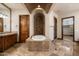 Luxurious bathroom featuring a soaking tub with stone surround, double vanity, and a separate shower at 3523 E Presidio Cir, Mesa, AZ 85213