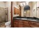 Bathroom featuring a tile shower, toilet, vanity mirror, and granite counters at 3523 E Presidio Cir, Mesa, AZ 85213