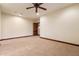 Bedroom with neutral carpet, ceiling fan, and dark wood trim throughout, providing a cozy atmosphere at 3523 E Presidio Cir, Mesa, AZ 85213