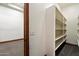 Walk-in closet featuring built-in shelving and carpet flooring at 3523 E Presidio Cir, Mesa, AZ 85213