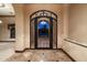 Elegant foyer features arched doorway and wrought iron gate, perfect for welcoming guests at 3523 E Presidio Cir, Mesa, AZ 85213