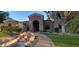 Detailed view of the inviting front exterior showcasing a beautifully landscaped yard and charming water feature at 3523 E Presidio Cir, Mesa, AZ 85213