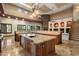Large kitchen island with granite countertops, custom cabinets, and stainless steel appliances at 3523 E Presidio Cir, Mesa, AZ 85213