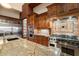 Elegant kitchen with granite countertops, stainless steel appliances, and wood cabinetry at 3523 E Presidio Cir, Mesa, AZ 85213
