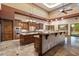 Gourmet kitchen featuring stone floors, dark wood cabinets, and modern appliances at 3523 E Presidio Cir, Mesa, AZ 85213