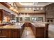 Gourmet kitchen with tile flooring, dark wood cabinets, and professional-grade appliances at 3523 E Presidio Cir, Mesa, AZ 85213