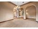Large living area with tan carpet, chandelier and arched doorways at 3523 E Presidio Cir, Mesa, AZ 85213