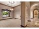 Open-concept living room with carpet, chandelier, and large windows for natural light at 3523 E Presidio Cir, Mesa, AZ 85213