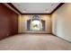 Living room with carpet flooring, a large arched window, and neutral-colored walls at 3523 E Presidio Cir, Mesa, AZ 85213