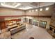 Spacious living room with a fireplace, high ceilings, and an open kitchen area at 3523 E Presidio Cir, Mesa, AZ 85213