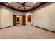 Spacious living room featuring a ceiling fan, carpet flooring, and an arched doorway with recessed lighting at 3523 E Presidio Cir, Mesa, AZ 85213