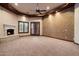 Cozy living room featuring a fireplace, a textured wall, and natural lighting at 3523 E Presidio Cir, Mesa, AZ 85213
