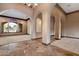 Spacious living room with tile and carpet flooring, arched doorways, and large window at 3523 E Presidio Cir, Mesa, AZ 85213